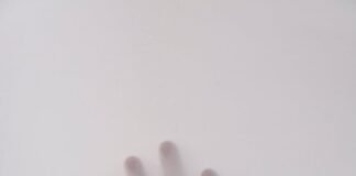 Top 10 Modern Horror Movies That Will Scare Your Socks Off (And Then Some) person s hand touching wall